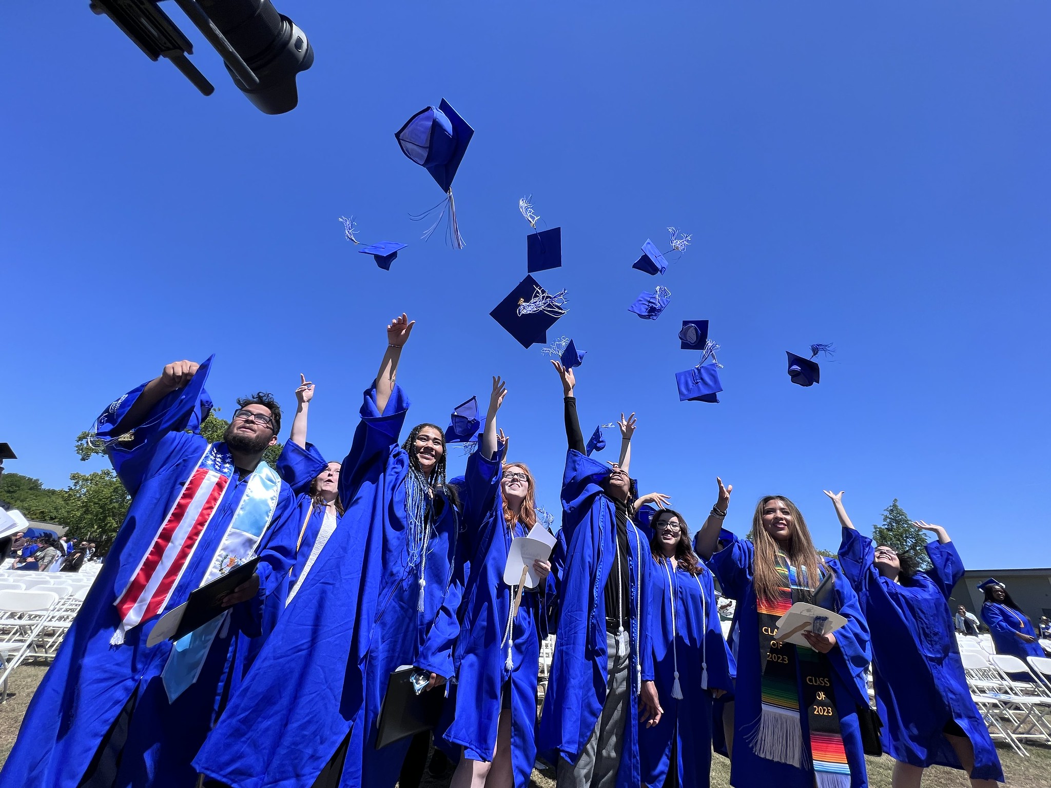 Graduates throwing their caps
