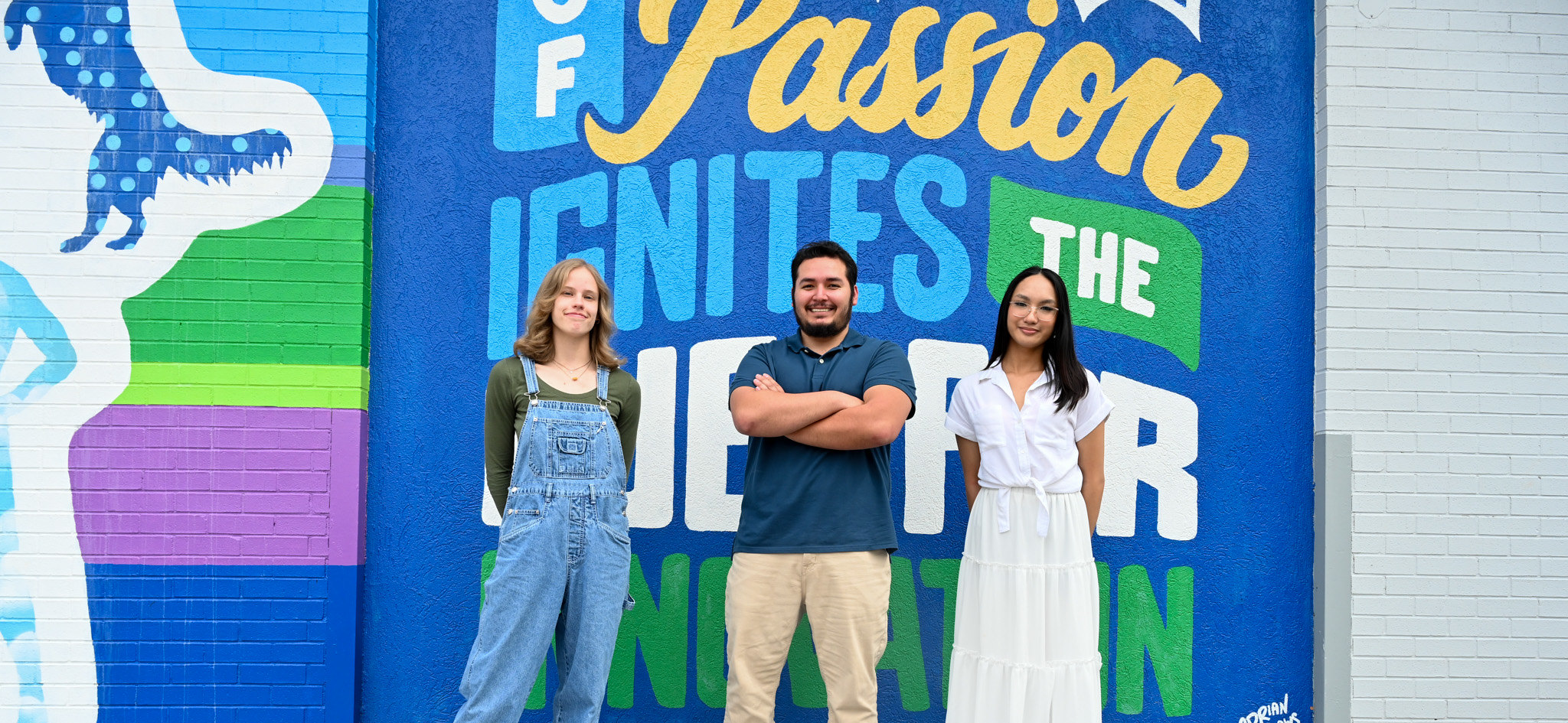 Image of student in front of mural