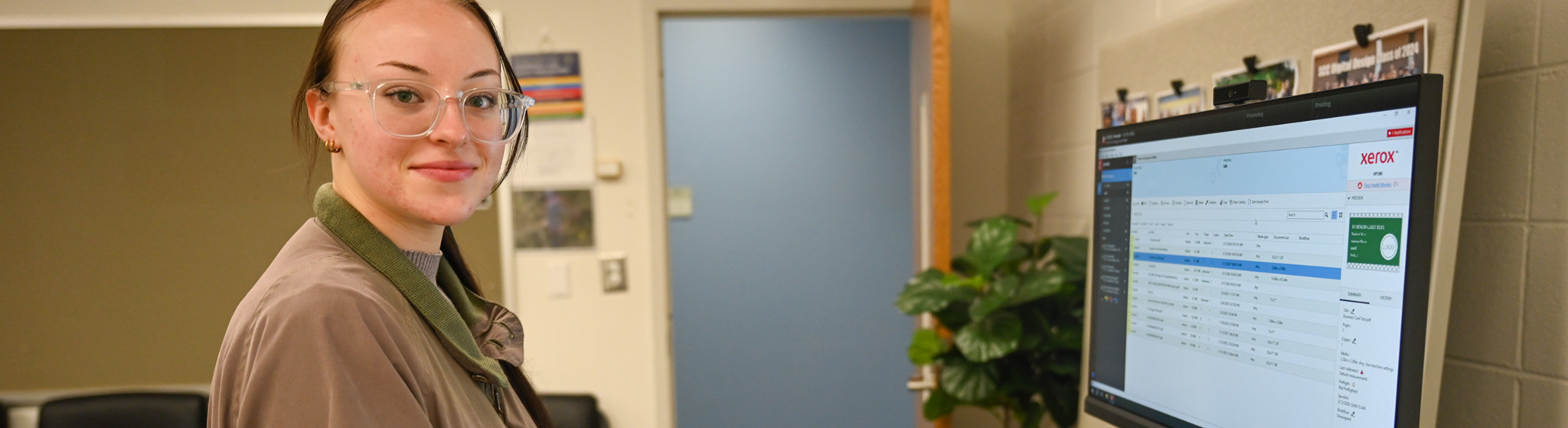 A Spartanburg Community College digital marketing student using a computer workstation in a campus computer lab