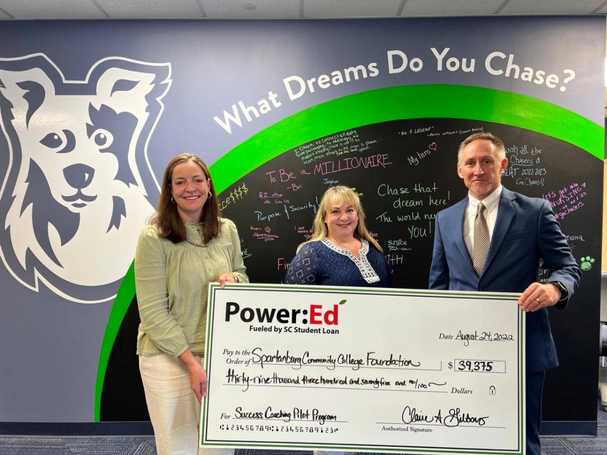 Pictured: Power:Ed Executive Director Claire Gibbons (center) presents Spartanburg Community College's Executive Director of Advancement, John Jaraczewski (right) and Dean of Student Success, Witney Fisher (left) with a check for funds to support the establishment of a Student Success Coach.