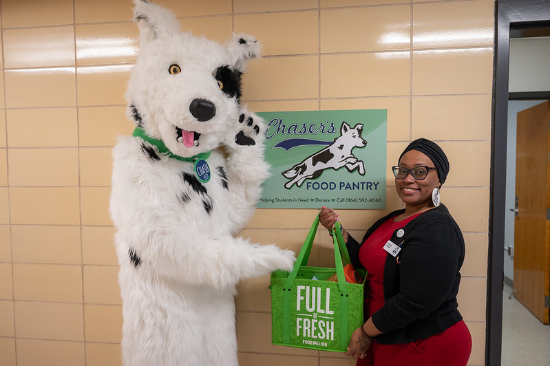 Chaser poses with staff member by the Chaser's Pantry