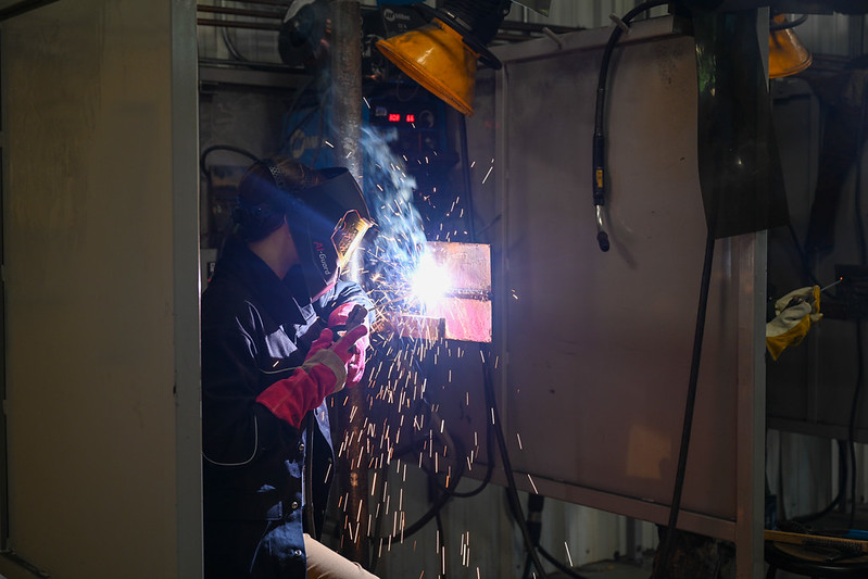 A student at SCC has welds a piece of metal in class.