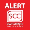 Red emergency alert icon for Spartanburg Community College featuring bold white uppercase text reading “ALERT” at the top, with the SCC logo centered below inside a rounded square border, including the words “SPARTANBURG Community College,” presented on a solid red background for high visibility and urgency.